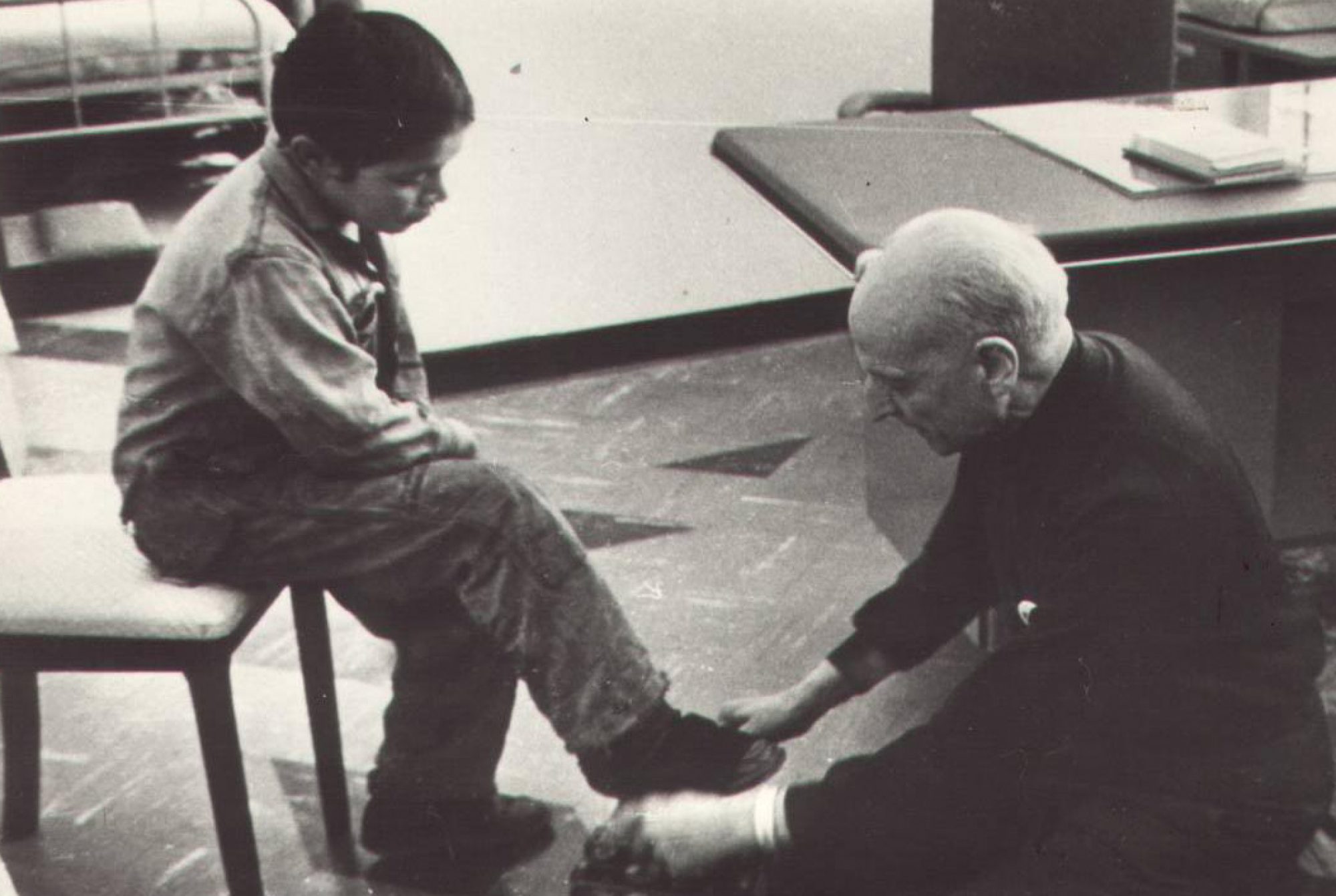 Fr Pedro Arrupe SJ shining shoes for a children in Quito, Ecuador in 1971.